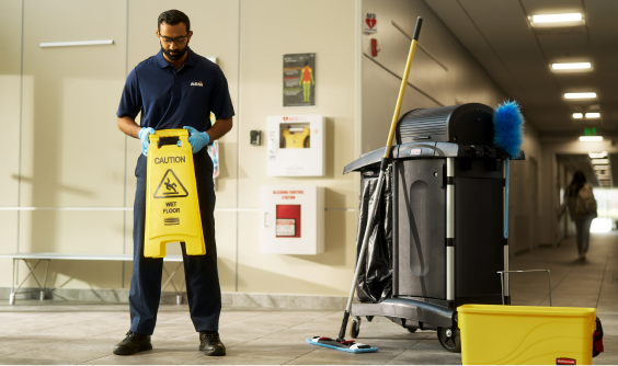 A male ABM employee getting ready to clean a room