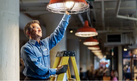 A man installs energy efficient lighting